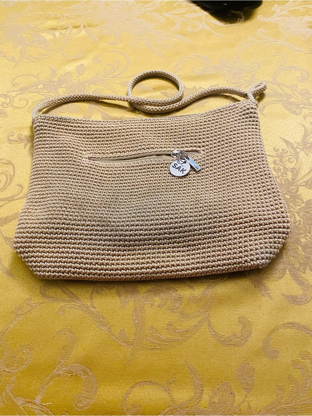 The Sak Tan Crochet Shoulder Bag with Signature Charm